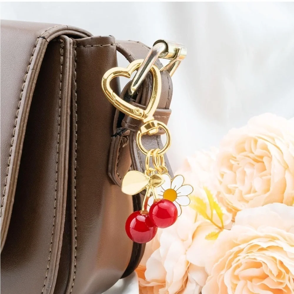 Red Cherry with Daisy bag accessories clip featuring gold hardware